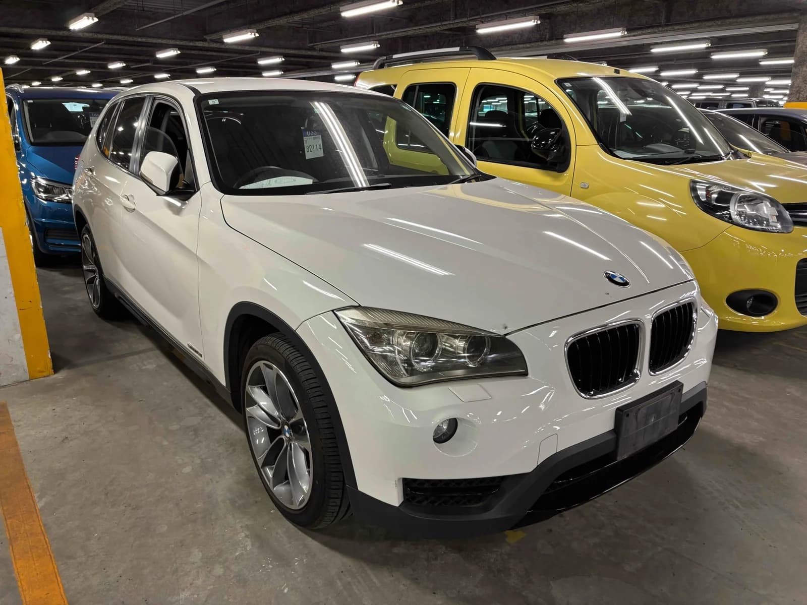 Front-left angle of white BMW X1 compact SUV