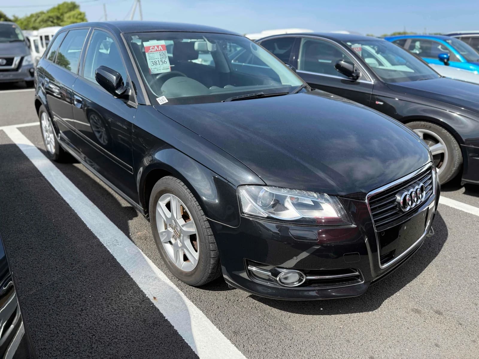 Front three-quarter view of a black Audi A4 Avant 1.4T wagon parked in an outdoor auction lot