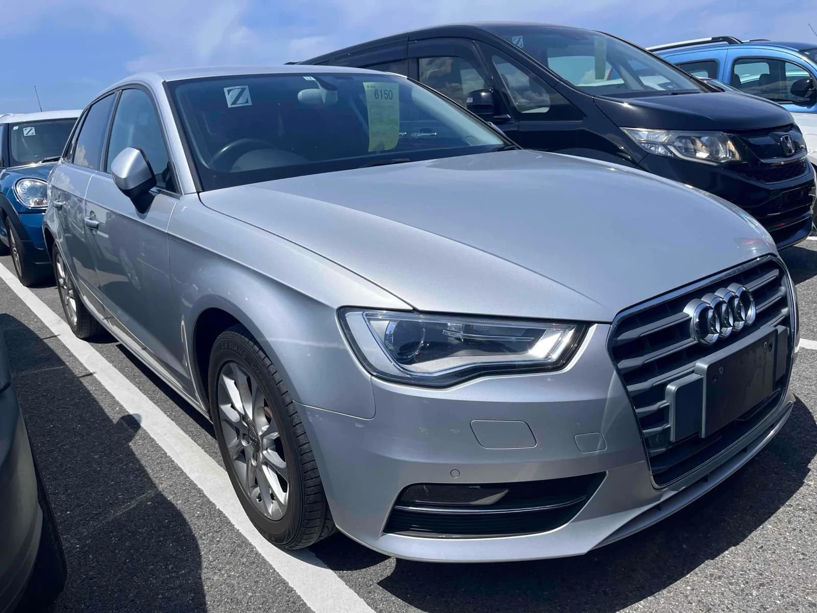 Front three-quarter view of a silver Audi A3 parked in an outdoor auction lot