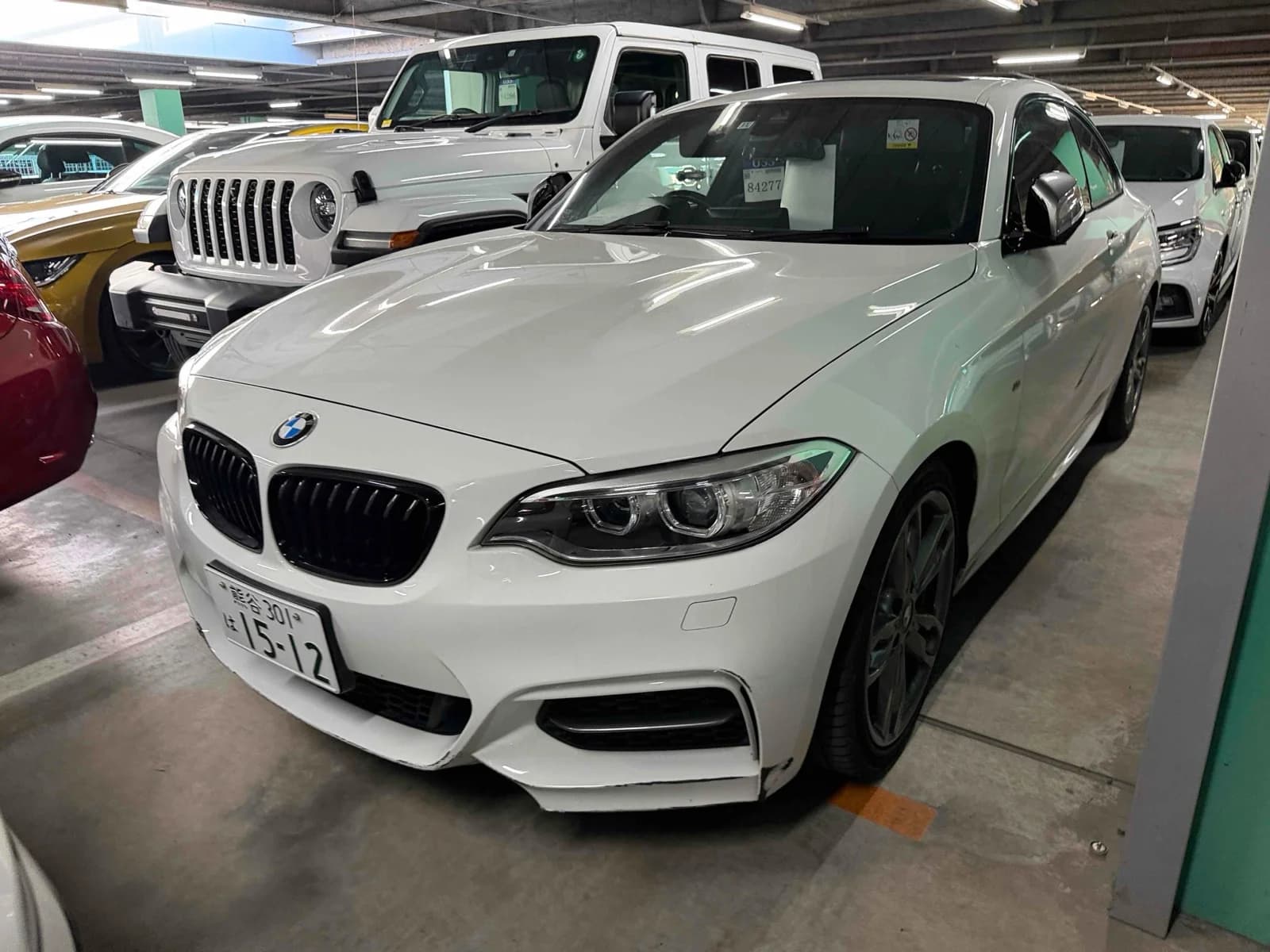 Front-left angle of white BMW 4-series coupe with LED headlights