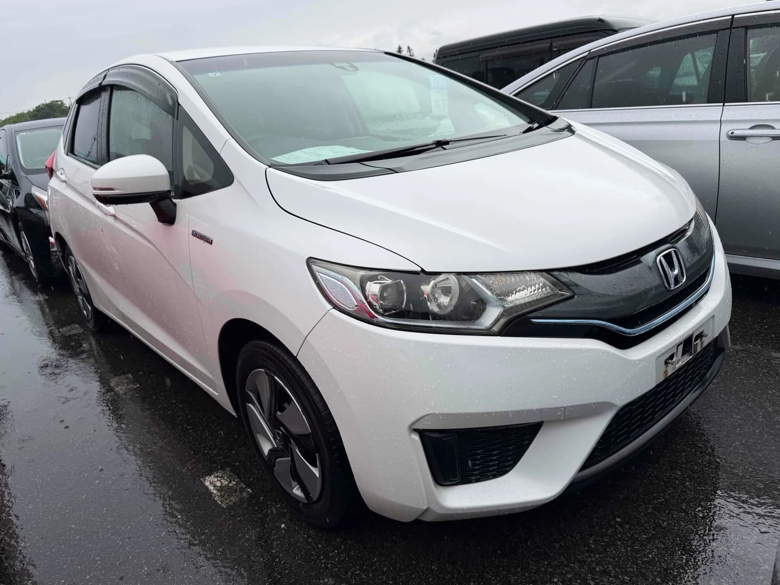 Honda Fit Hybrid - front-left 3/4 exterior with white paint