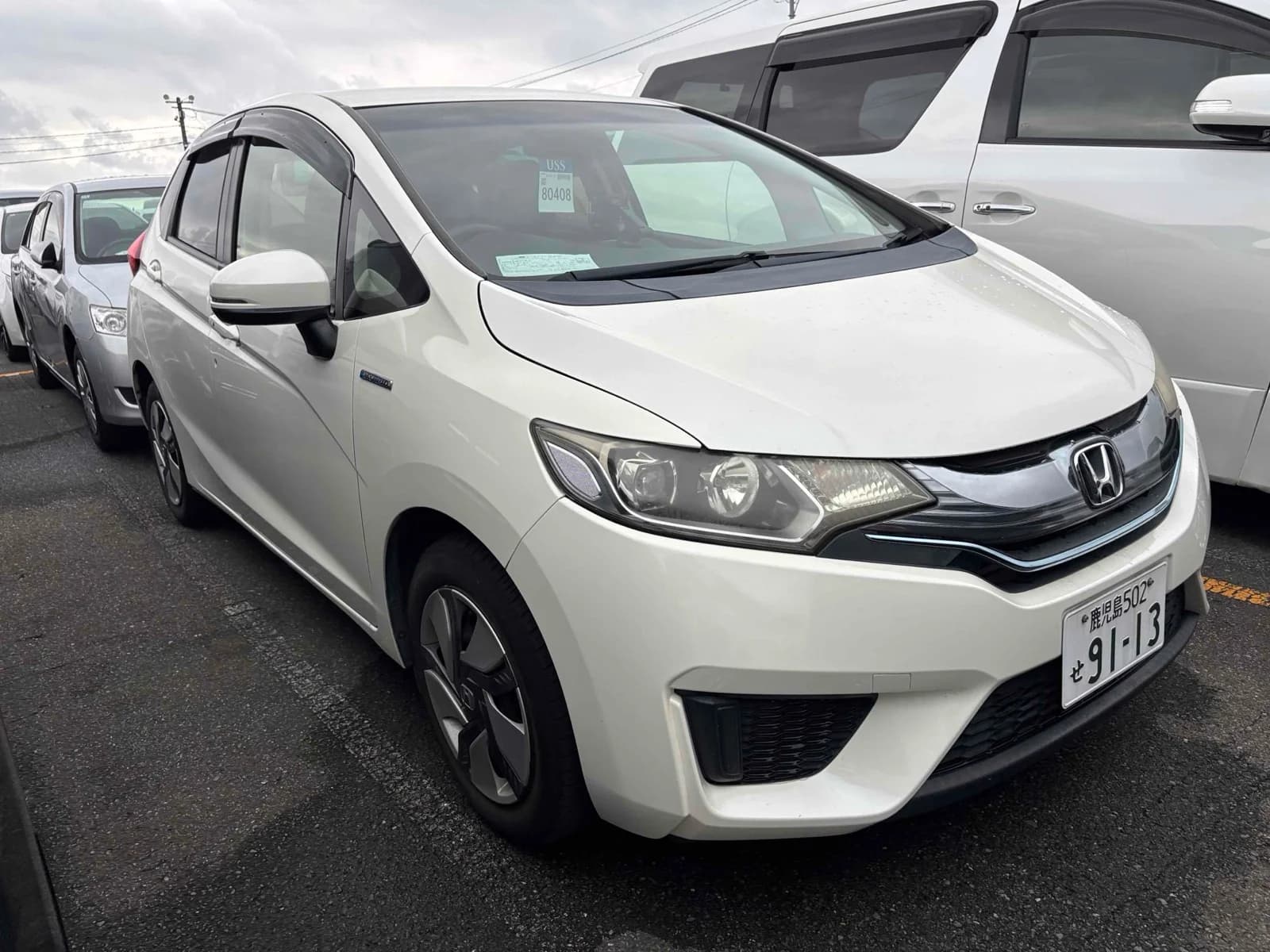Honda Fit Hybrid - front-left 3/4 exterior with white paint