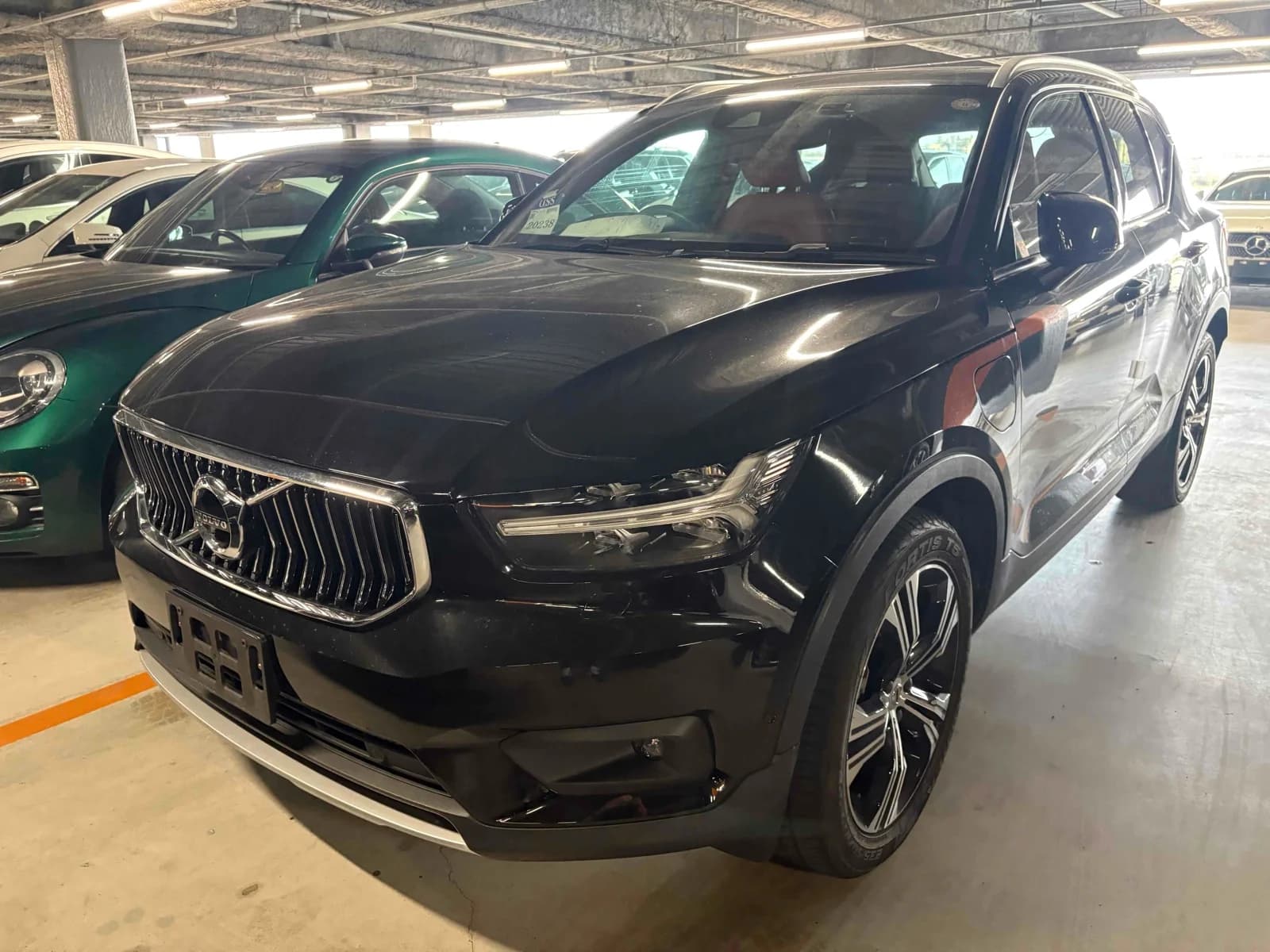 Volvo XC40 luxury compact SUV - Front-left 3/4 view showing black pearl paint, LED headlights, modern Volvo grille
