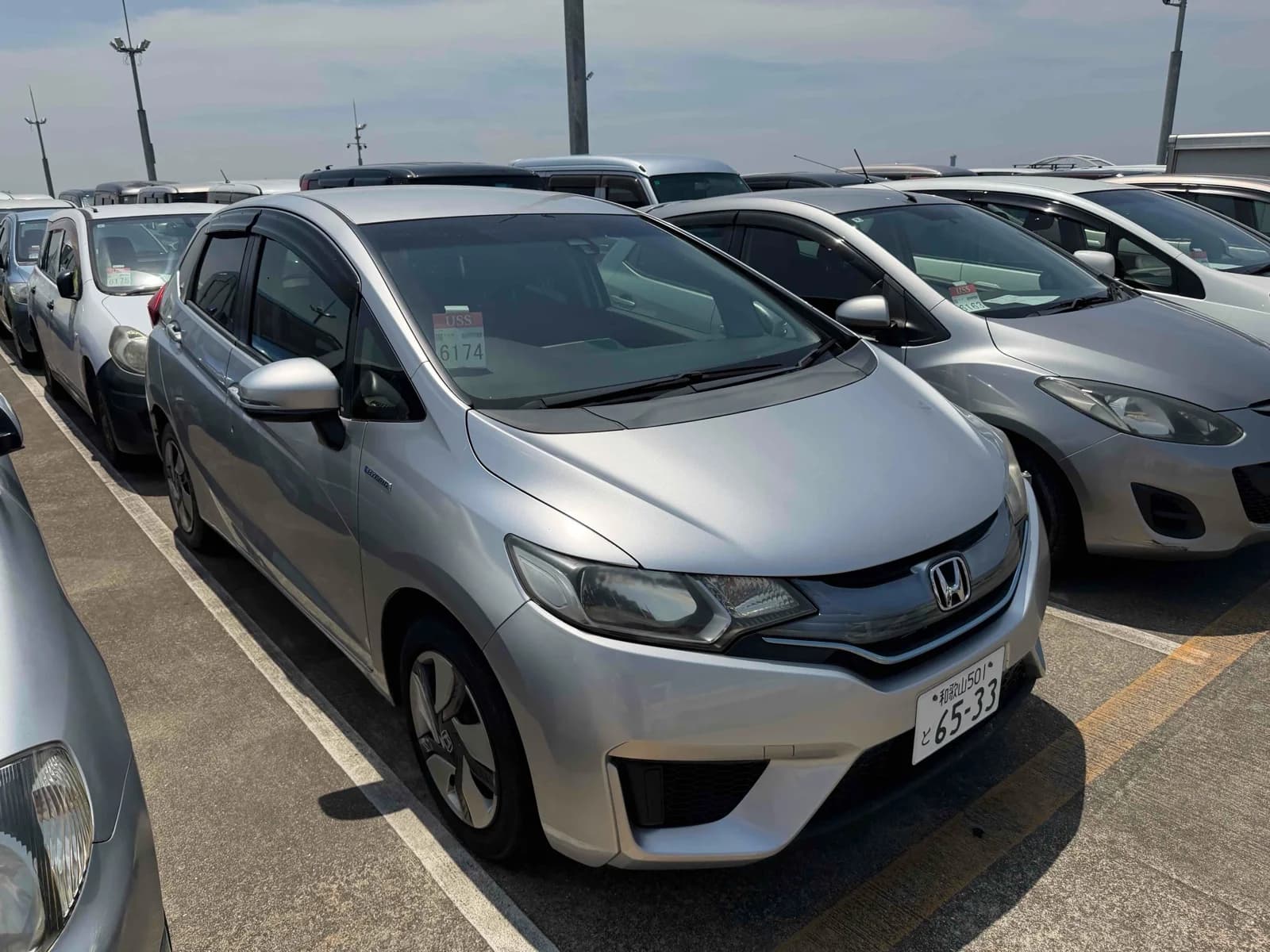 Honda Fit Hybrid - front-left 3/4 exterior with pearl white paint in daylight