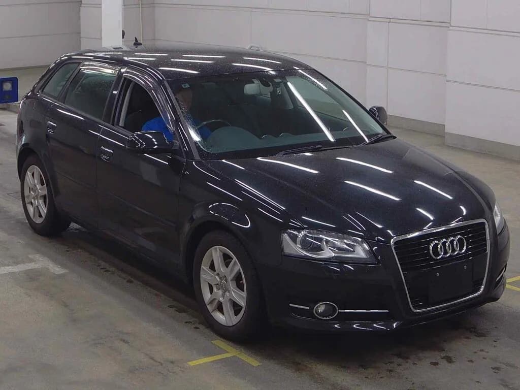 Black Audi Q5 compact SUV - front-left 3/4 view in parking structure