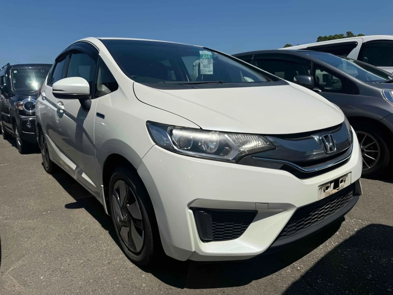 Honda Fit Hybrid - front-left 3/4 exterior with white paint