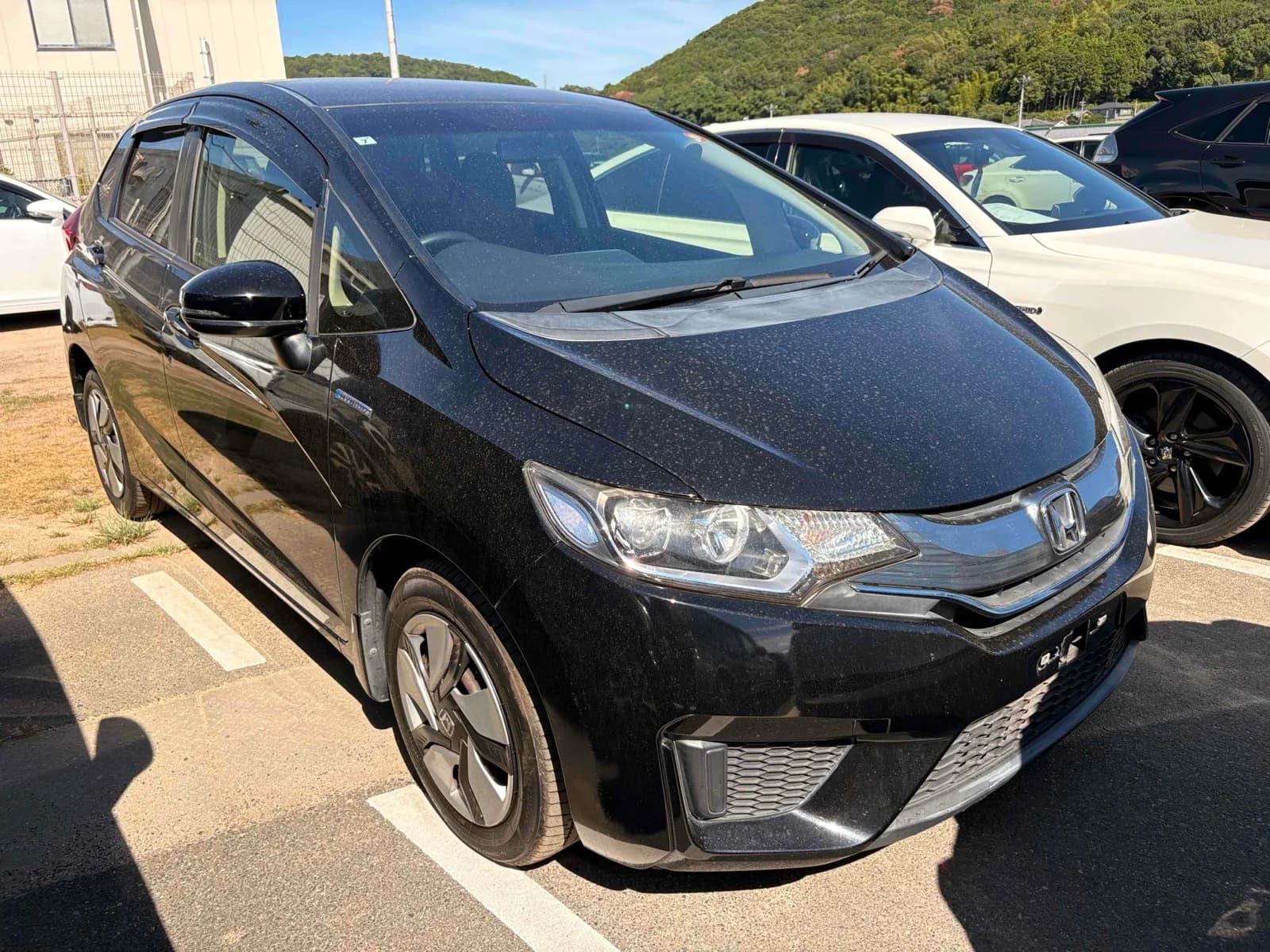 Honda Fit Hybrid - front-left 3/4 exterior with white paint