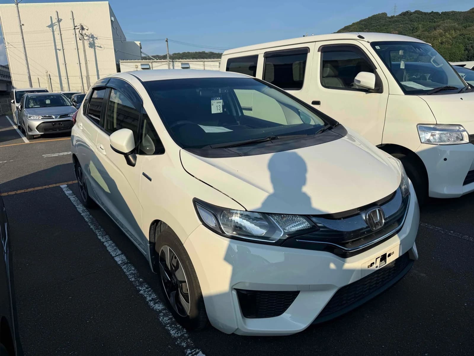 Honda Fit Hybrid - front-left 3/4 exterior view with white pearl paint and LED headlights