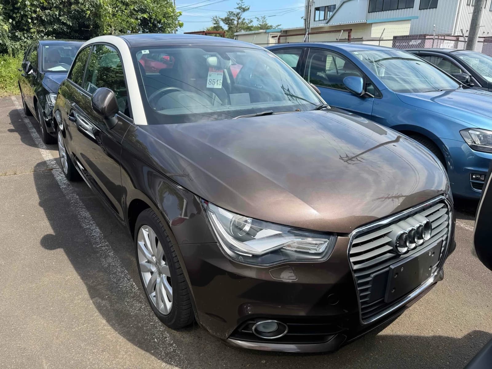 Black Audi A1 compact hatchback front-left 3/4 view at outdoor auction lot