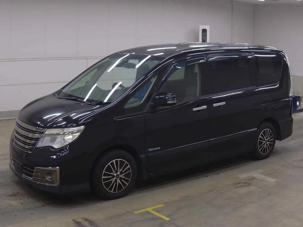 Nissan Serena e-Power minivan - Front-left exterior view in an indoor inspection bay with black paint, chrome grille, and multi-spoke alloy wheels
