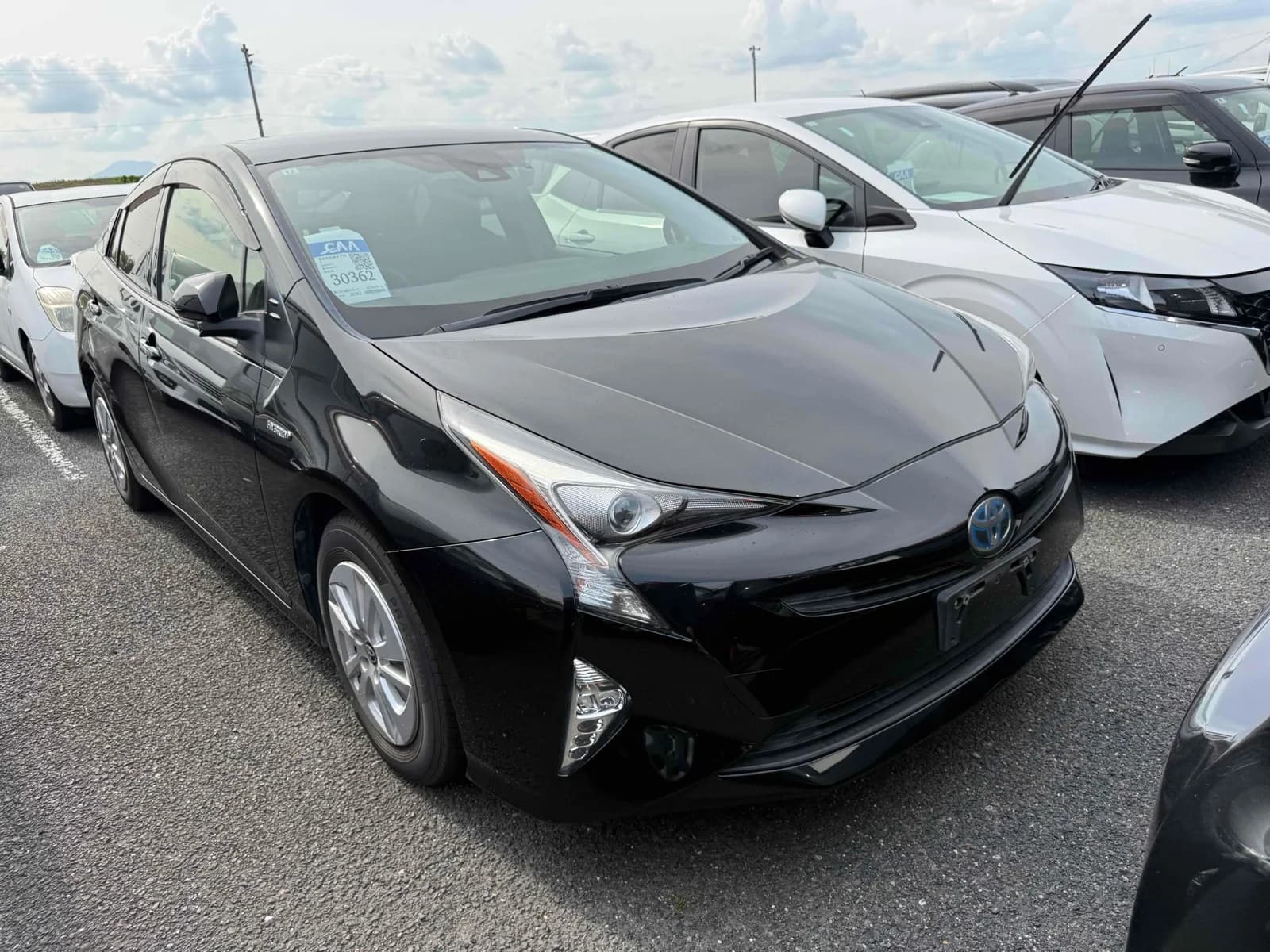 Black Toyota Prius hybrid sedan exterior front angle view at auction yard