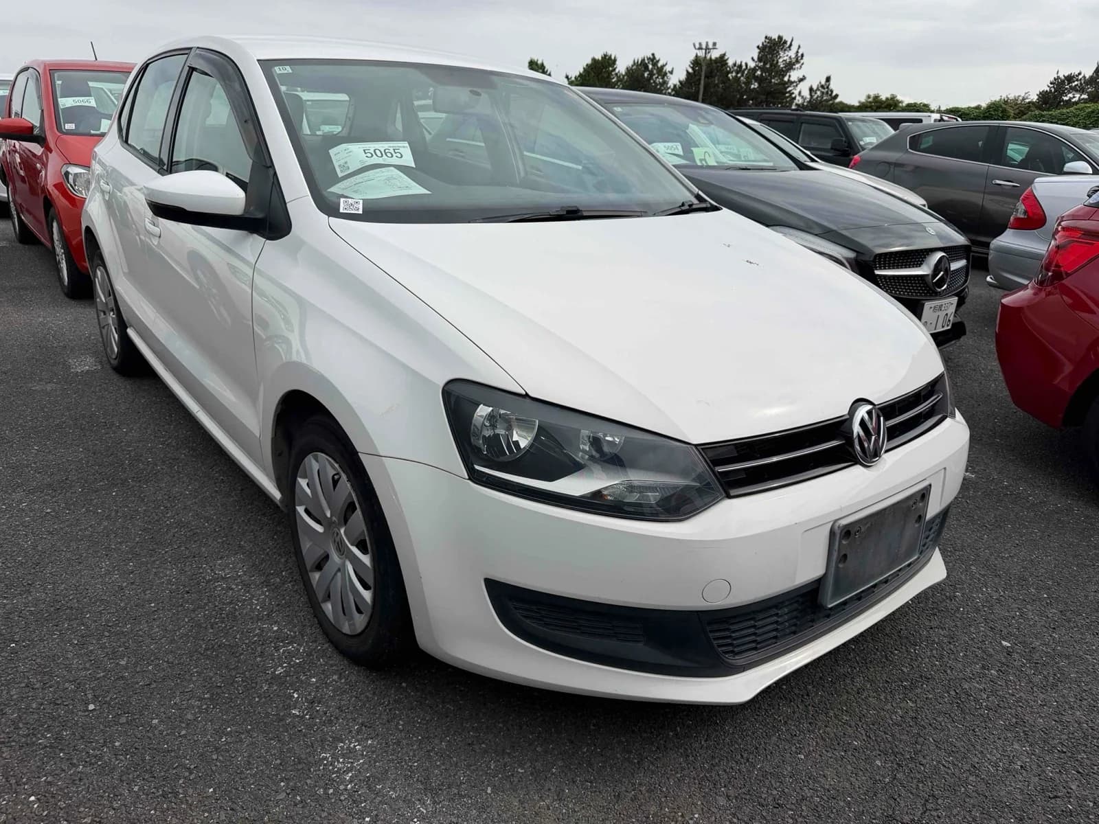 White Volkswagen Golf TSI 2.0T sedan exterior front three-quarter angle in parking lot