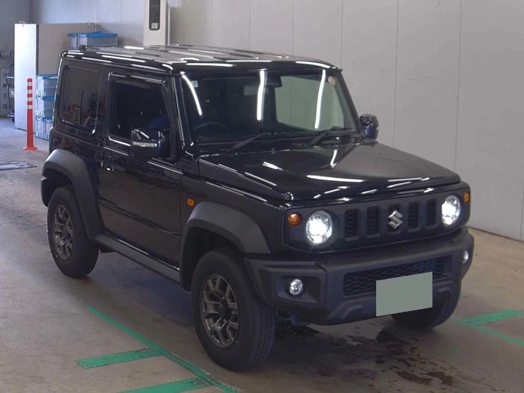 Suzuki Jimny SUV - Front-right exterior view with black paint, roof rails, round LED headlights, and bronze-finish alloy wheels