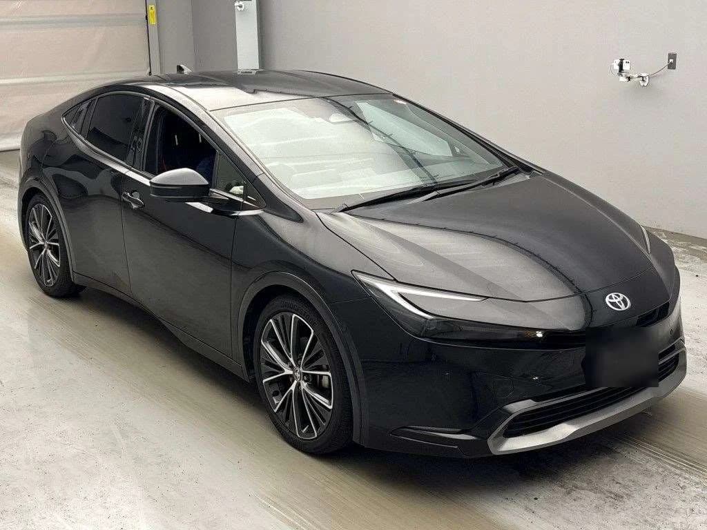 Toyota Prius hatchback - Front-right exterior view with black paint, sharp LED headlights, chrome Toyota emblem, and alloy wheels