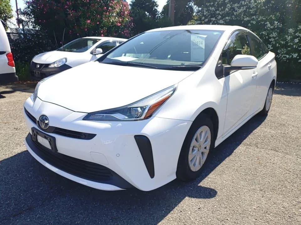 Toyota Prius hatchback - Front-left exterior view with white paint, LED headlights, and auction tag on windshield