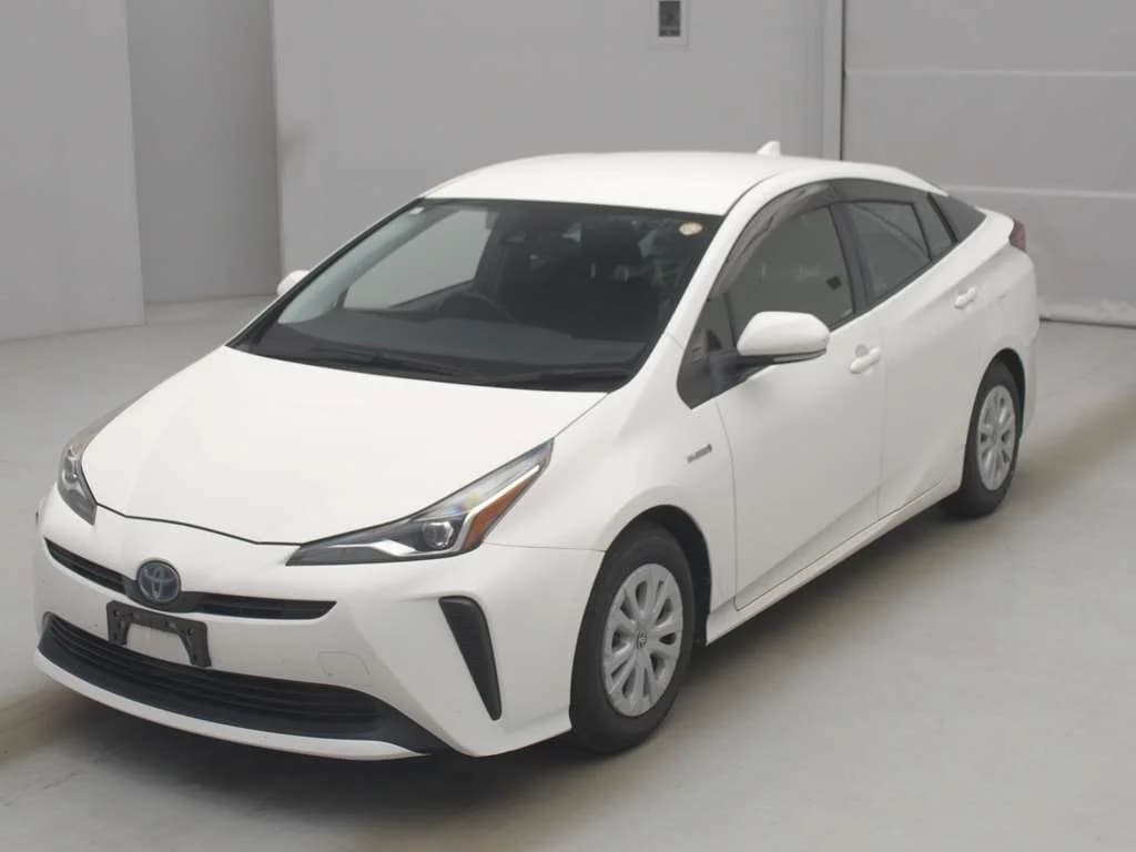 2019 Toyota Prius S hybrid in white - front-left 3/4 studio view with slim LED headlights, vertical bumper accents, window visors, and 15-inch wheel covers