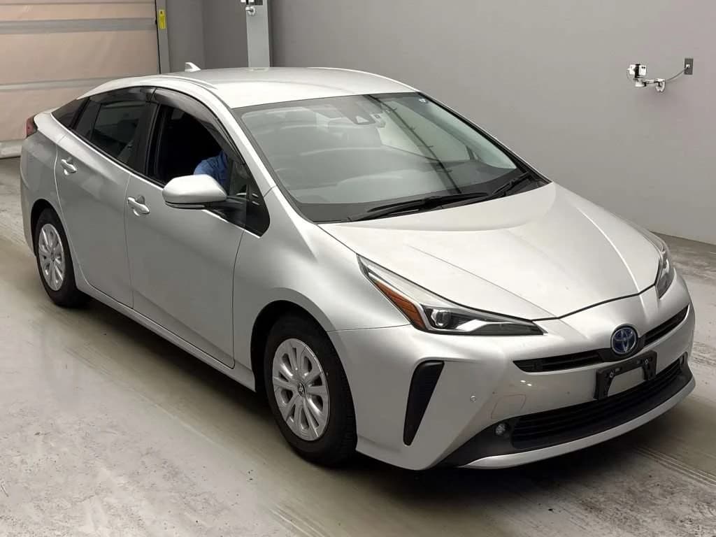 2021 Toyota Prius S hybrid in silver metallic - front-right 3/4 studio view with slim LED headlights, LED fog lights, and 15-inch wheel covers