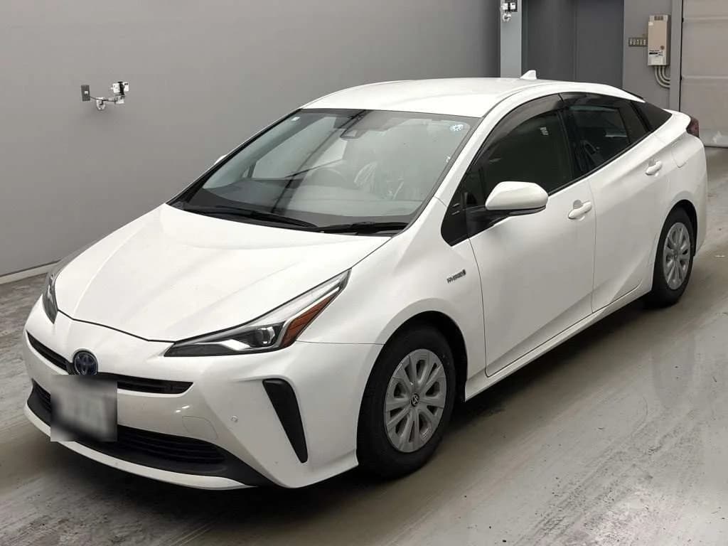 2019 Toyota Prius S hybrid in white - front-left 3/4 studio view with slim LED headlights, vertical bumper accents, and wheel covers