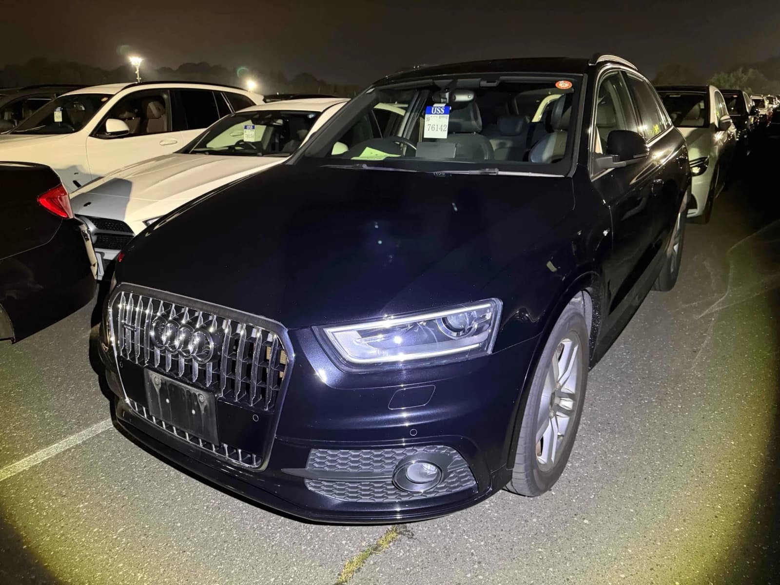 2014 Audi Q3 2.0 TFSI quattro S line in black - front-right 3/4 view with chrome vertical-slat grille, xenon LED headlights, and fog lights